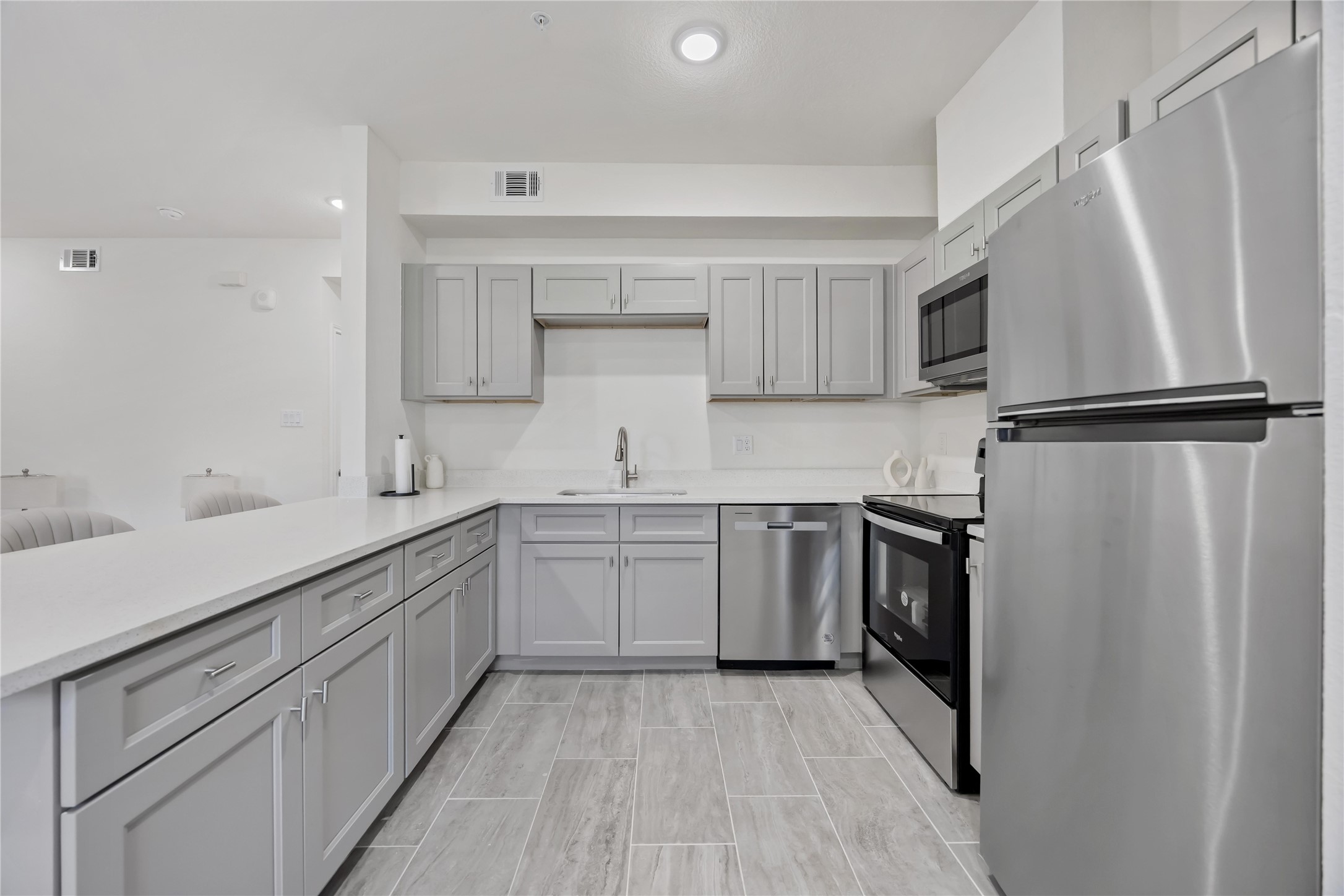 9129 Brandon Street, Unit A7 Houston, TX 77051 - Photo 8 of 15 a kitchen with a sink appliances and cabinets