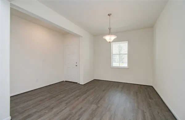 a big room with wooden floor and windows