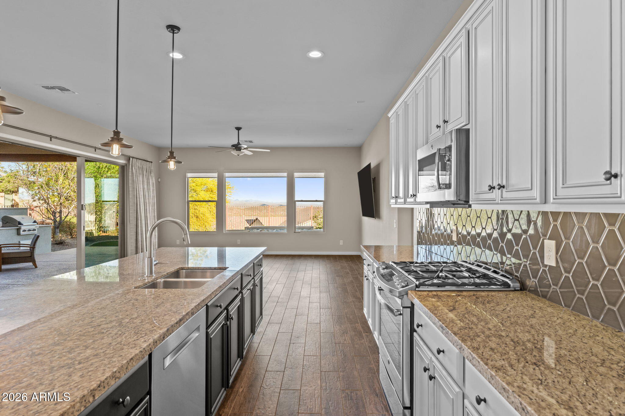 3675 Gold Ridge Road Wickenburg, AZ 85390 - Photo 12 of 58 a kitchen with sink stove and cabinets