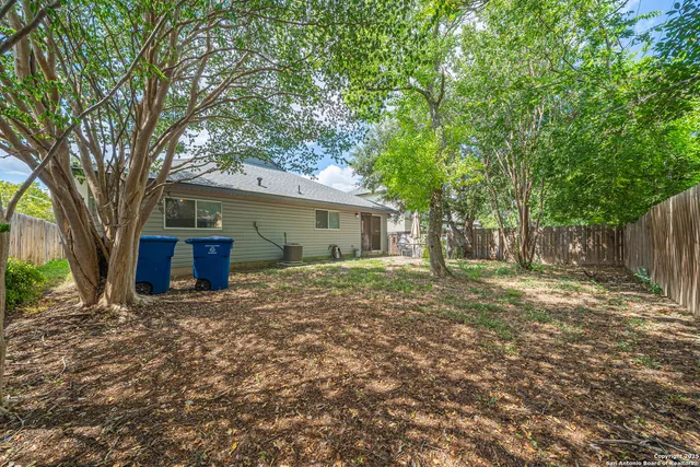 a view of a house with yard and a tree