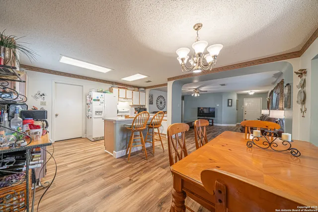 a view of a dining room with furniture and a chandelier