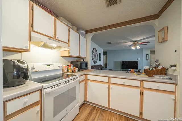 a kitchen with a stove a sink and a microwave