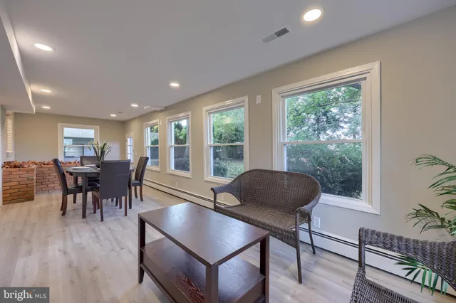 a dining room with furniture and wooden floor