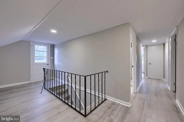 a view of hallway with wooden floor