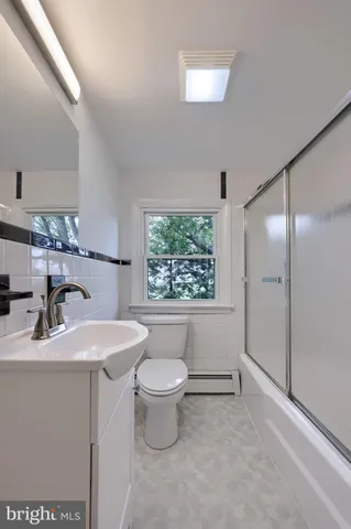 a bathroom with a sink toilet a mirror and shower