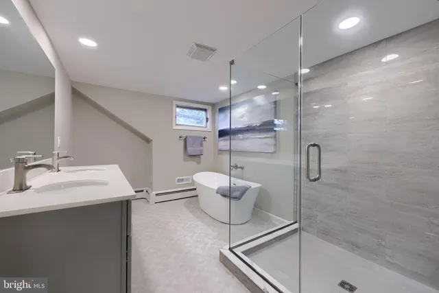 a bathroom with a double vanity sink mirror and shower