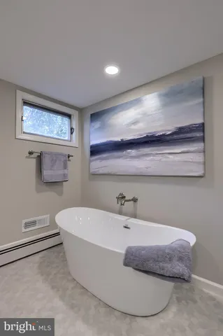 a bathroom with a bathtub and a sink