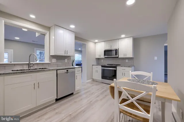 a kitchen with a sink cabinets and wooden floor