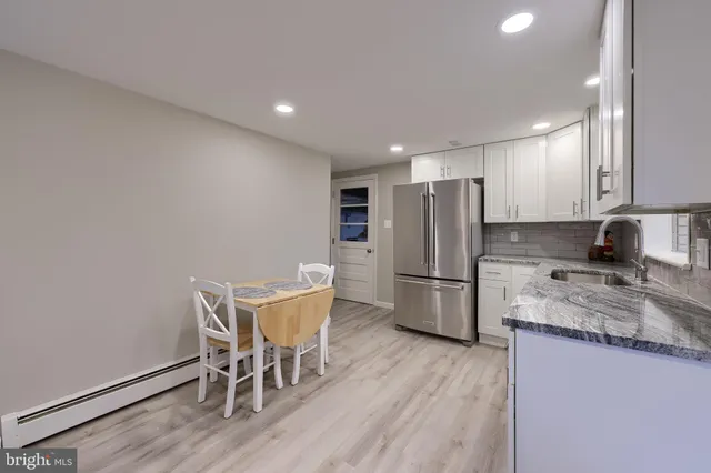 a kitchen with stainless steel appliances granite countertop a refrigerator microwave and wooden cabinets