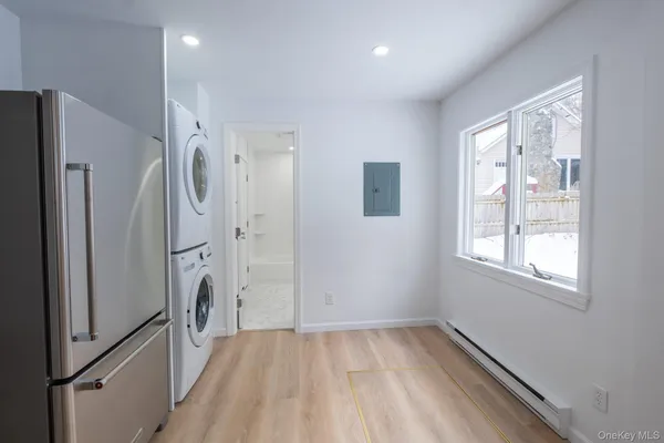 a kitchen with stainless steel appliances granite countertop a sink a stove a refrigerator and cabinets