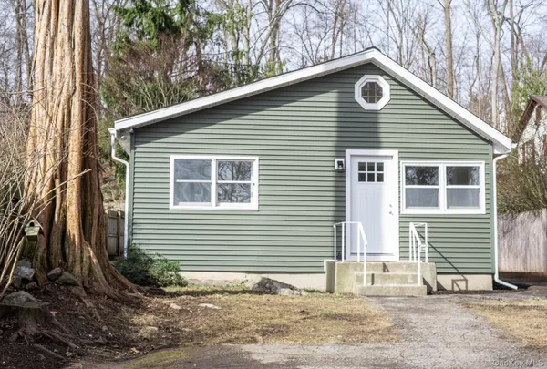 a backyard of a house with table and chairs