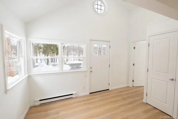 a view of room with window and wooden floor