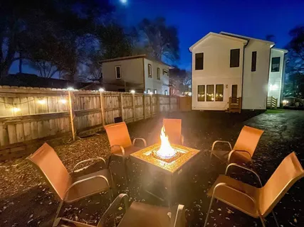 a view of a patio with couches table and chairs with wooden fence
