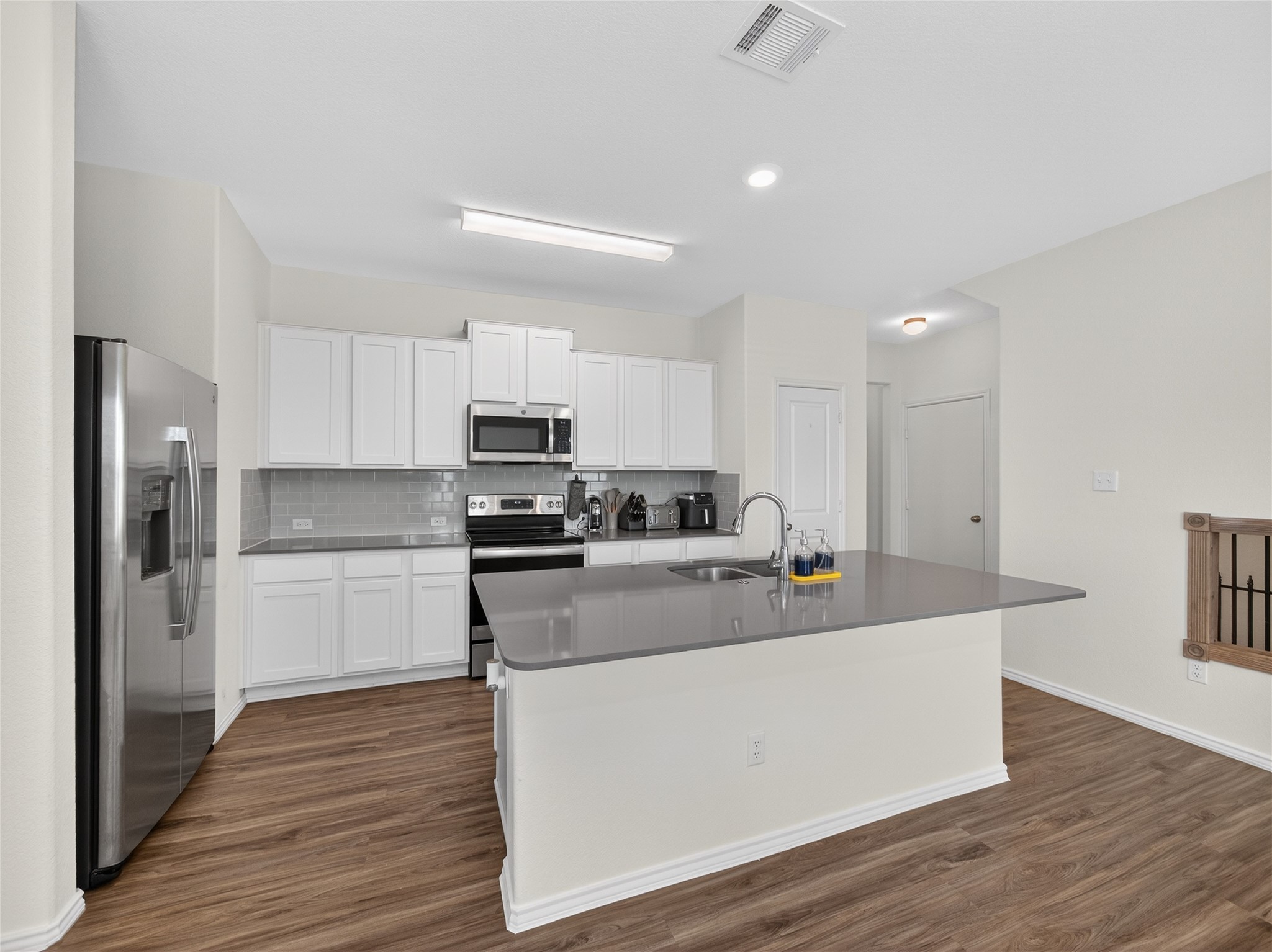 156 Greatest Gift Way Jarrell, TX 76537 - Photo 8 of 40 a kitchen with stainless steel appliances a refrigerator sink and cabinets