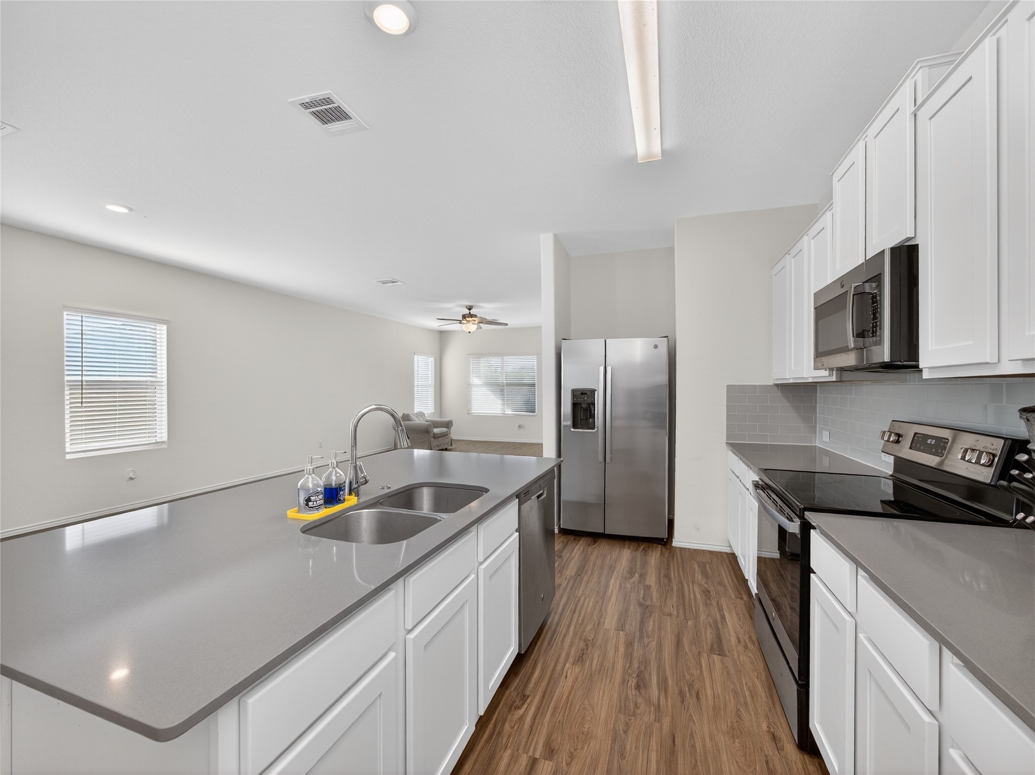 156 Greatest Gift Way Jarrell, TX 76537 - Photo 9 of 40 a kitchen with stainless steel appliances granite countertop a sink stove and refrigerator