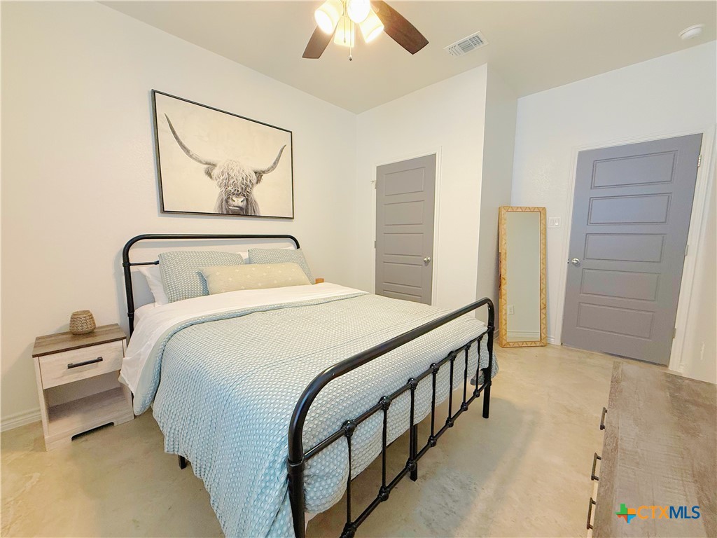 211 Riptide Road Temple, TX 76501 - Photo 6 of 11 a bedroom with a bed and a chandelier