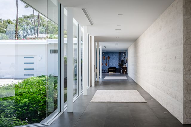 a living room with furniture potted plant and a chandelier