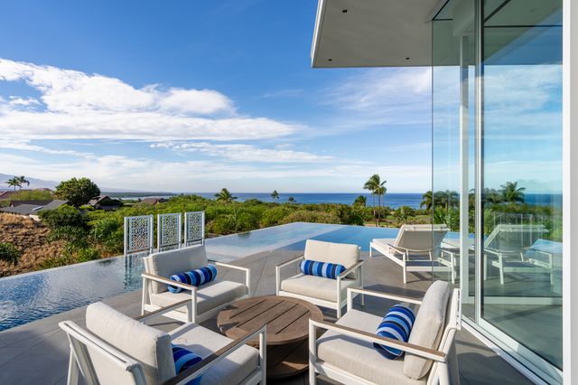 a view of a porch with furniture and a garden