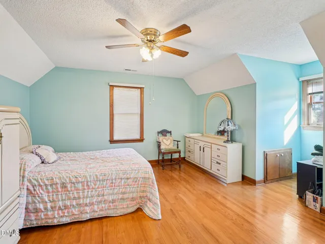 a bedroom with a bed and a dresser