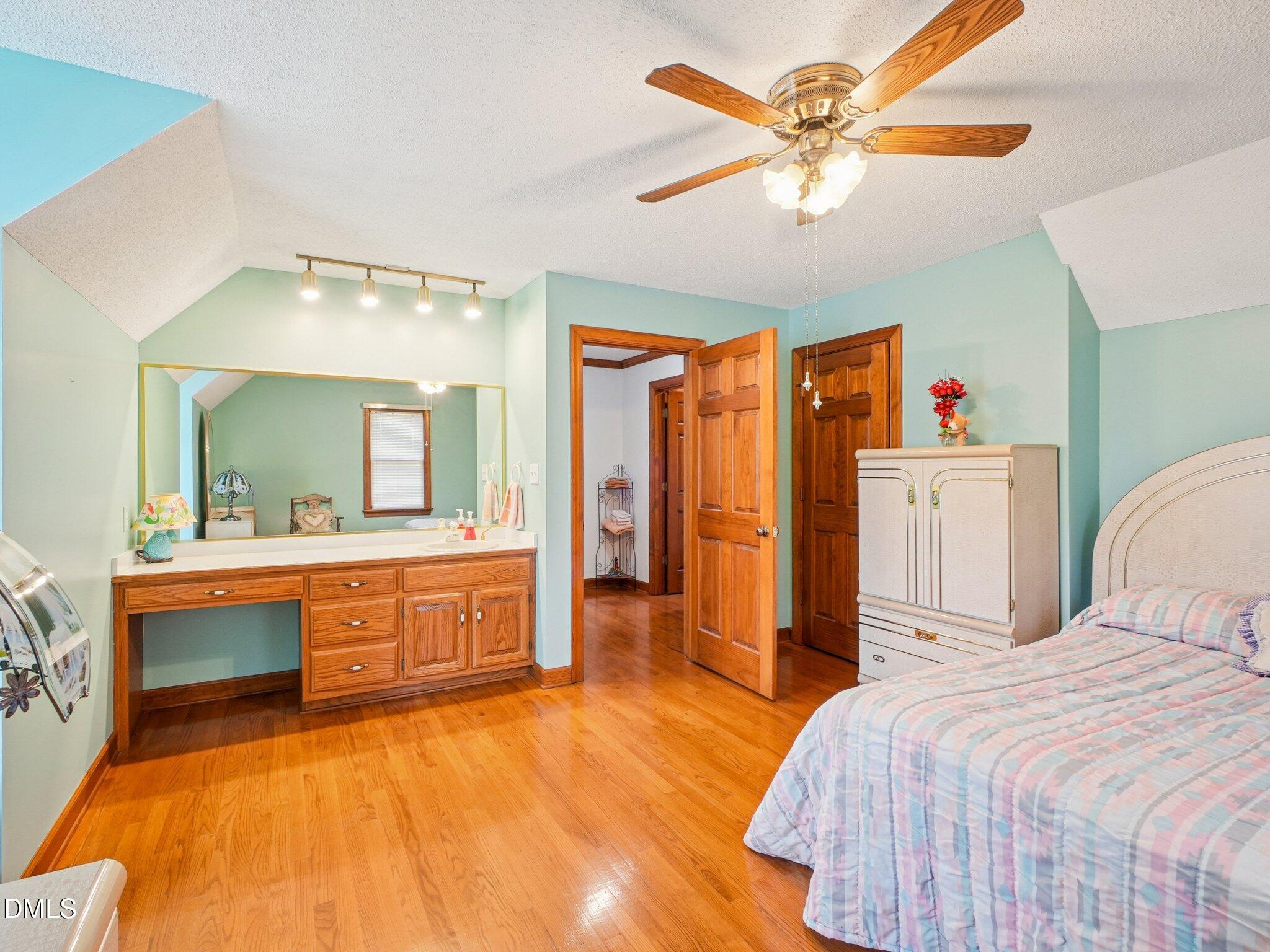 750 Stephenson Road Benson, NC 27504 - Photo 12 of 21 a bedroom with a bed and a chandelier