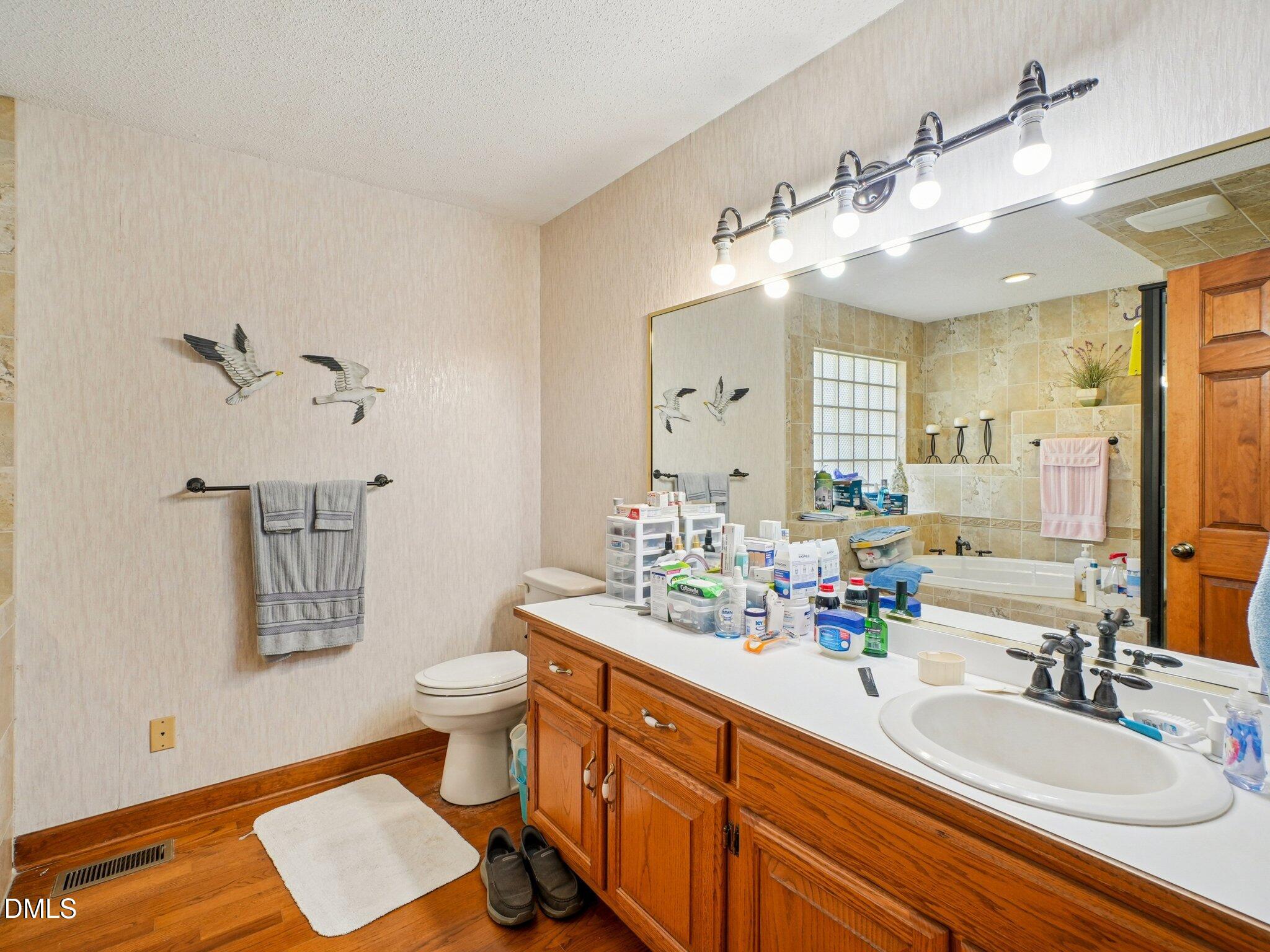 750 Stephenson Road Benson, NC 27504 - Photo 13 of 21 a bathroom with a double vanity sink mirror and toilet
