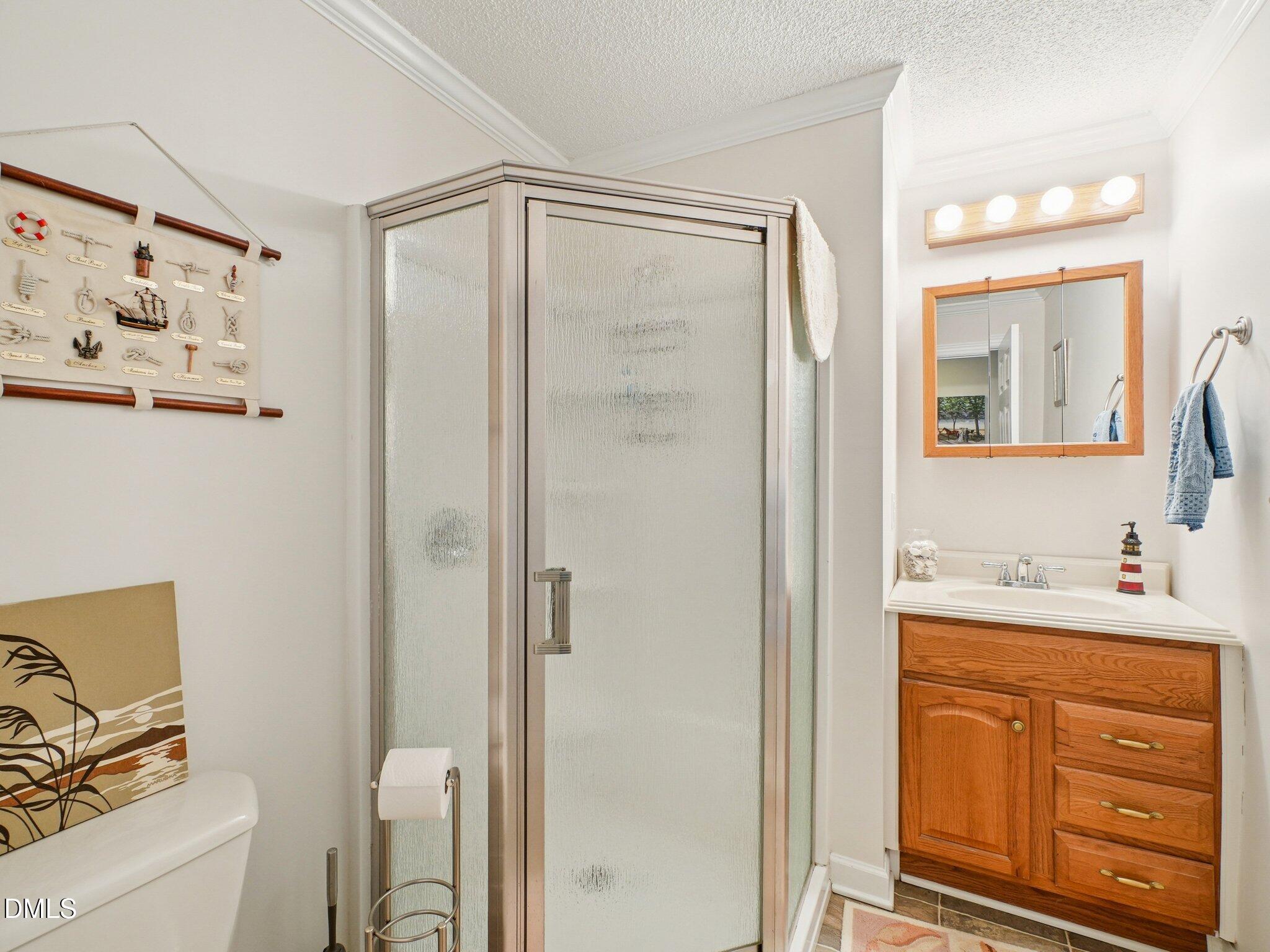 750 Stephenson Road Benson, NC 27504 - Photo 15 of 21 a bathroom with a granite countertop sink a mirror a vanity and a shower