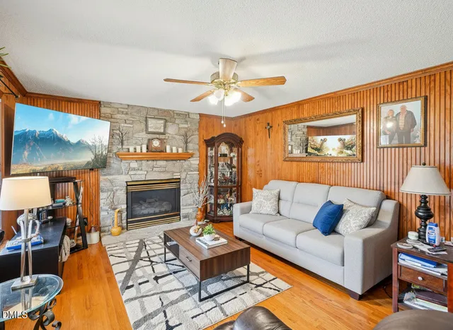 a living room with furniture a fireplace and a flat screen tv