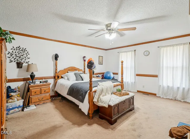 a bedroom with a bed and window