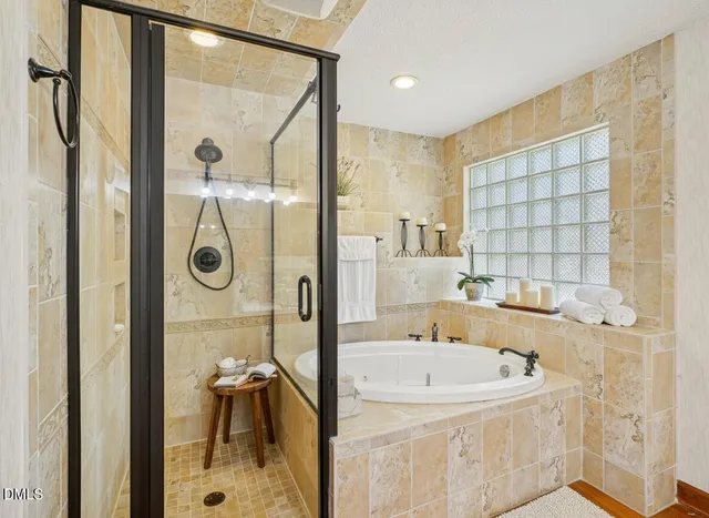 a bathroom with a tub a sink and a shower