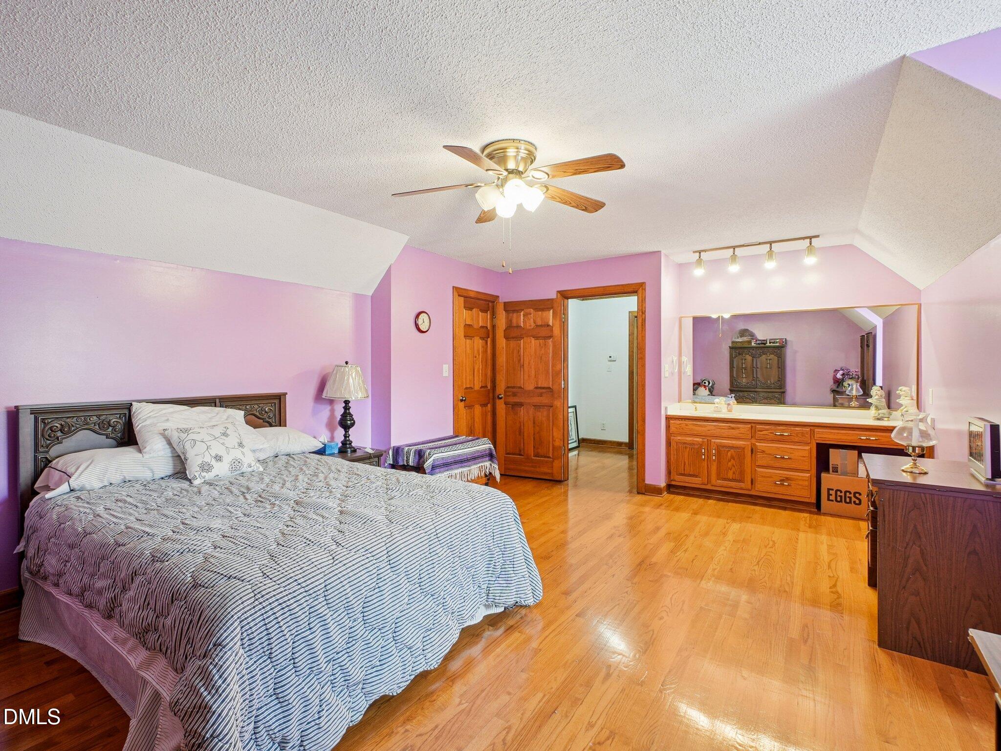 750 Stephenson Road Benson, NC 27504 - Photo 10 of 21 a bed room with a bed and a chandelier