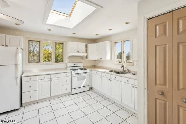 a kitchen with a sink cabinets and window