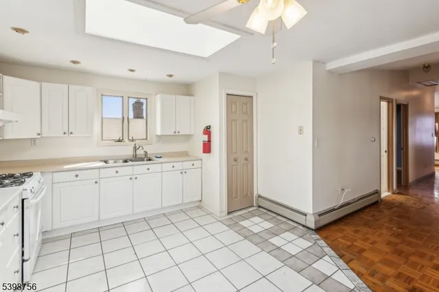 a kitchen with white cabinets sink and white appliances