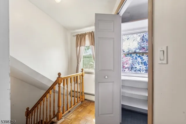 a view of a hallway with windows and stairs