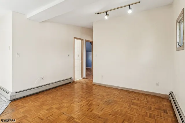 a view of a kitchen with a sink and dishwasher a stove top oven with wooden floor