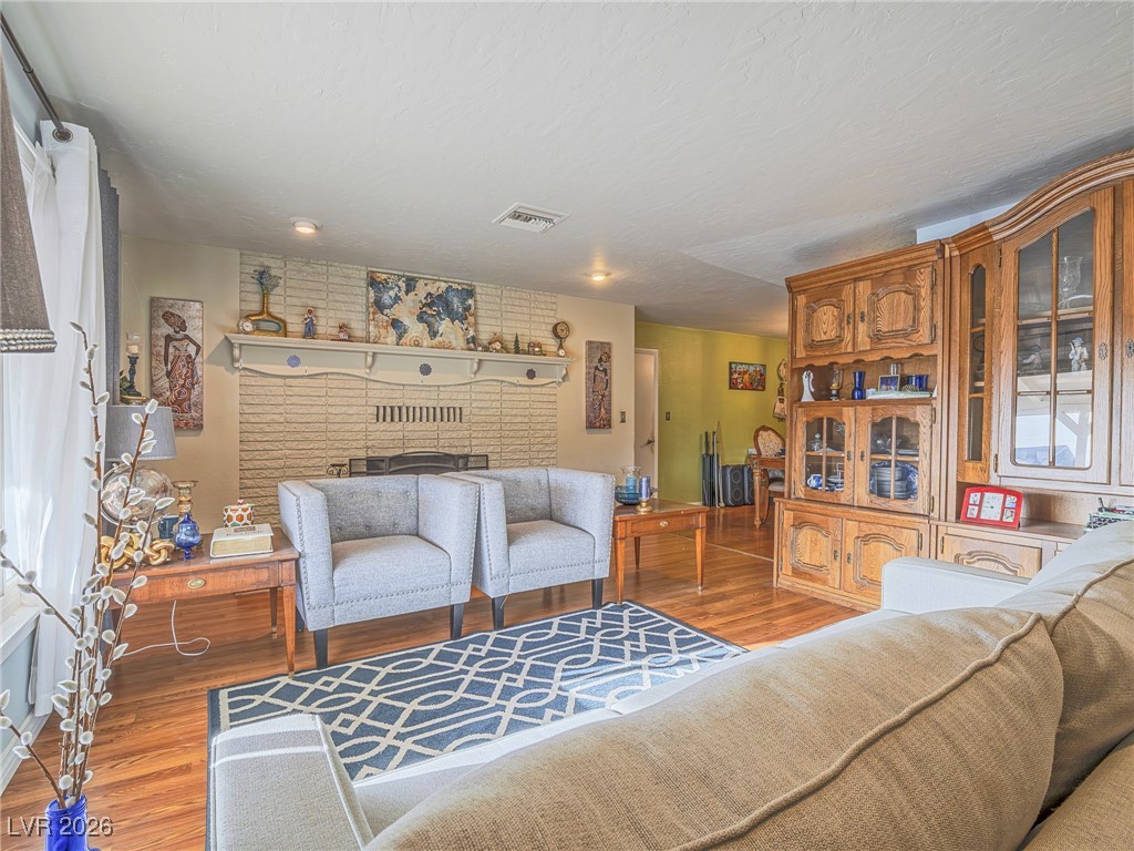 846 Fairview Drive Henderson, NV 89015 - Photo 14 of 39 Living area with wood finished floors and a fireplace