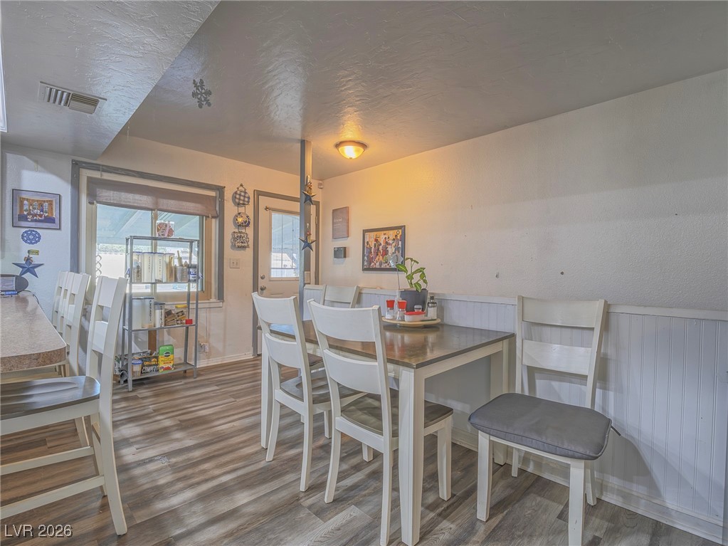 846 Fairview Drive Henderson, NV 89015 - Photo 21 of 39 Dining area featuring a textured ceiling and wood finished floors