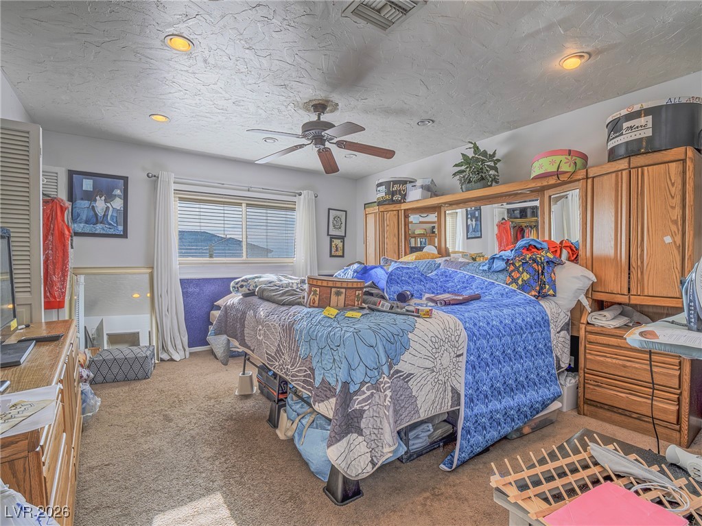 846 Fairview Drive Henderson, NV 89015 - Photo 24 of 39 Bedroom with light colored carpet, a textured ceiling, a ceiling fan, and recessed lighting