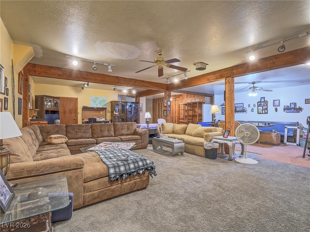 846 Fairview Drive Henderson, NV 89015 - Photo 31 of 39 Living room with rail lighting, carpet, a textured ceiling, beam ceiling, and ceiling fan
