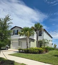 a front view of a house with a yard and garage