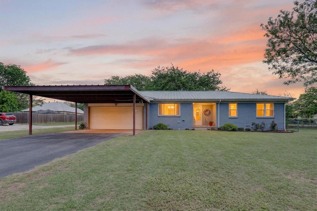 a view of a house with a yard and garage