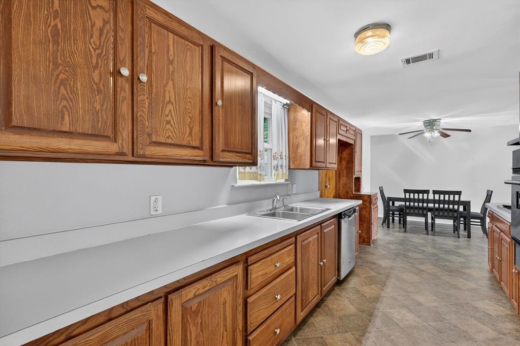 624 North Ave A Springtown, TX 76082 - Photo 12 of 29 a kitchen with stainless steel appliances granite countertop sink stove and cabinets