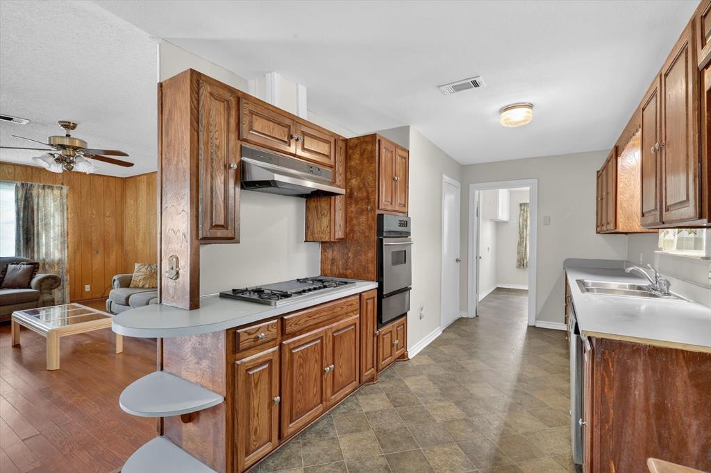 624 North Ave A Springtown, TX 76082 - Photo 13 of 29 a kitchen with stainless steel appliances granite countertop a sink stove and cabinets