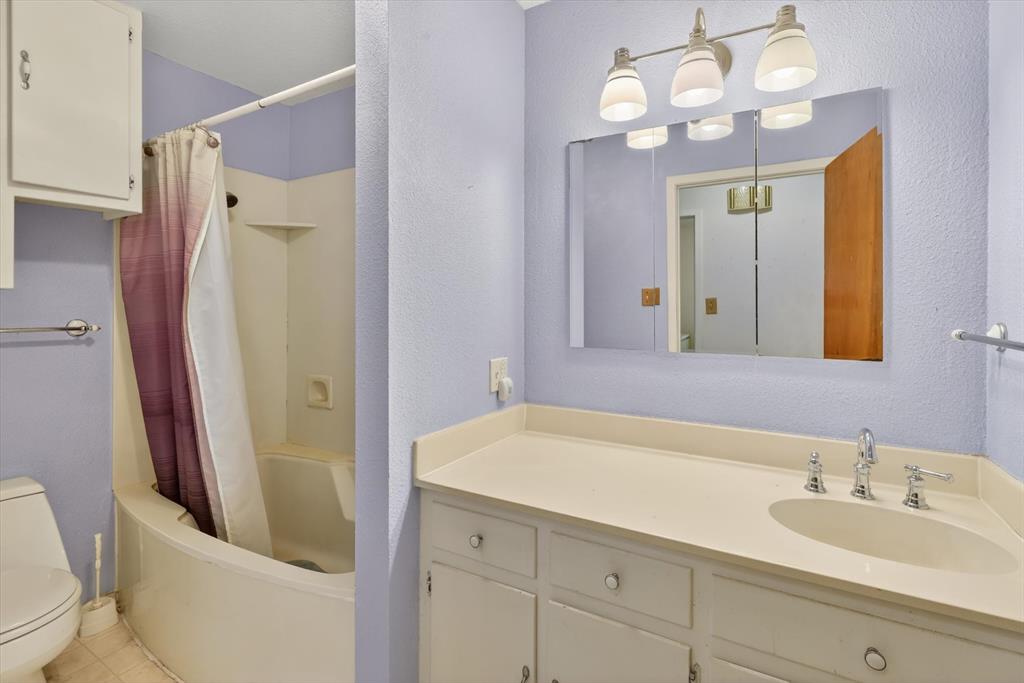 624 North Ave A Springtown, TX 76082 - Photo 17 of 29 a bathroom with a sink a toilet and a mirror