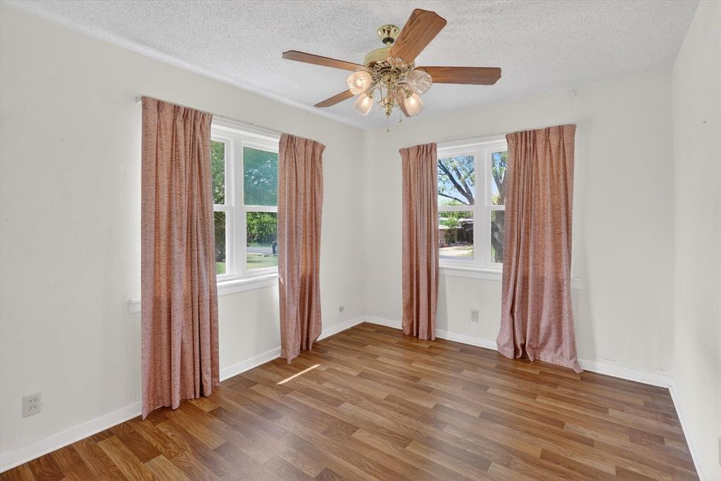 624 North Ave A Springtown, TX 76082 - Photo 18 of 29 a view of a livingroom with a chandelier fan and windows