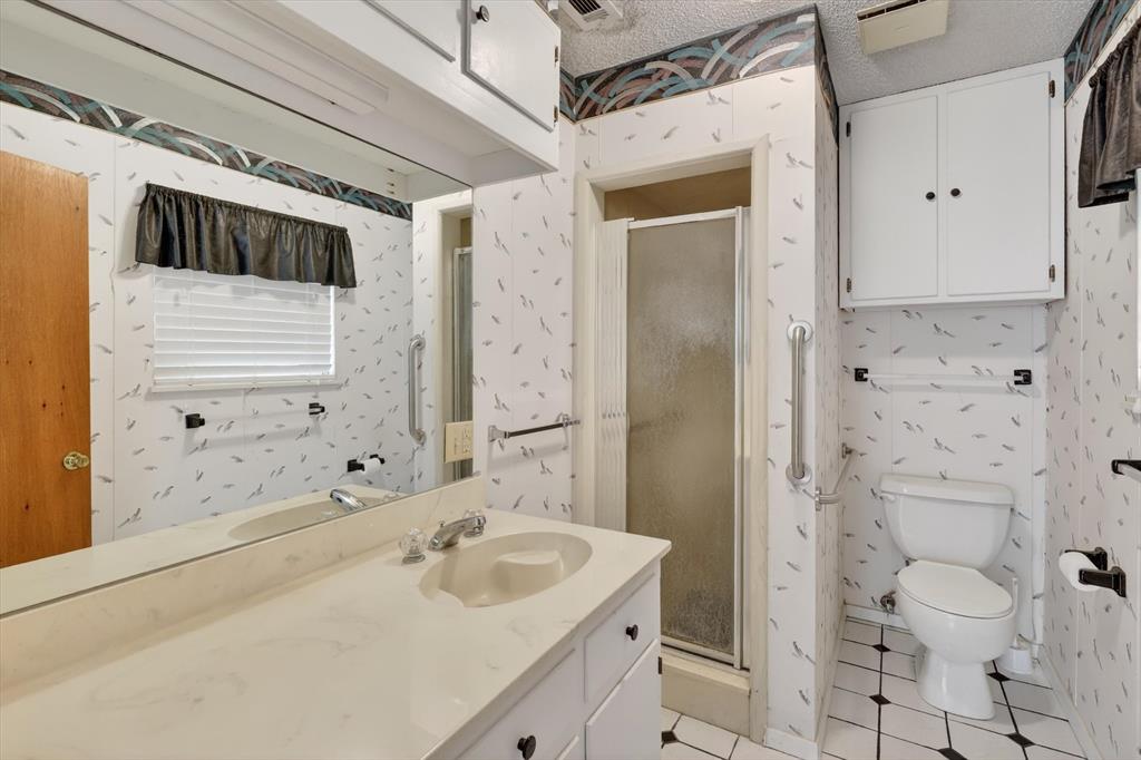 624 North Ave A Springtown, TX 76082 - Photo 22 of 29 a bathroom with a sink a toilet and shower