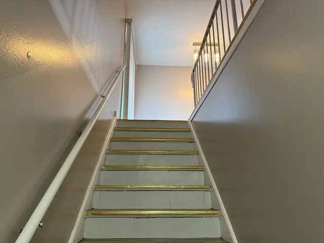 a living room with furniture and a dining table