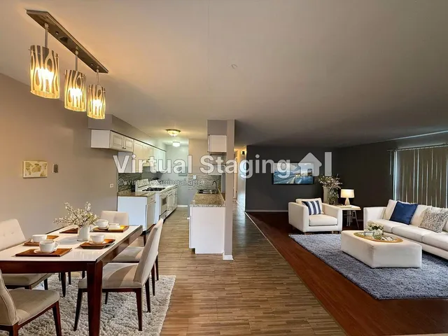 a view of kitchen with furniture and wooden floor