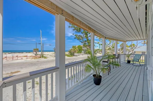 a dining room with furniture a chandelier and wooden floor