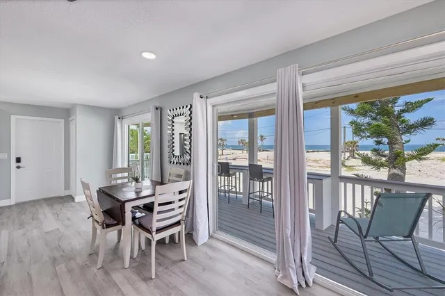 a large bedroom with a bed and a flat tv screen on dresser