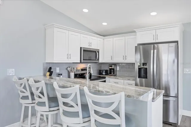 a view of a house with a yard and potted plants